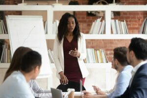 Female leader addressing a team in a meeting