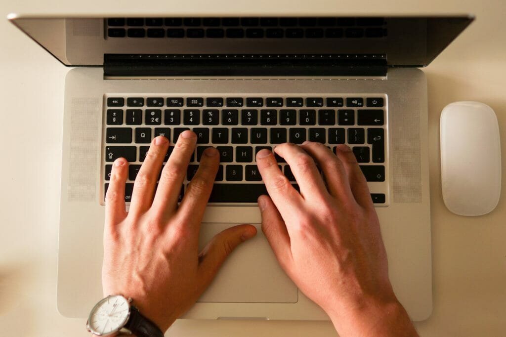 hands typing on a keyboard