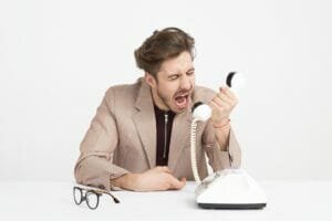 A man yelling at the phone