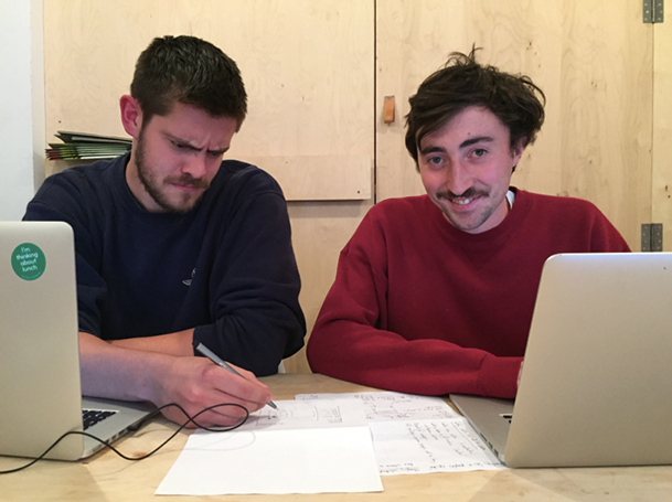 George (left) struggles to decipher Neil's wireframe, which he's quite proud of.