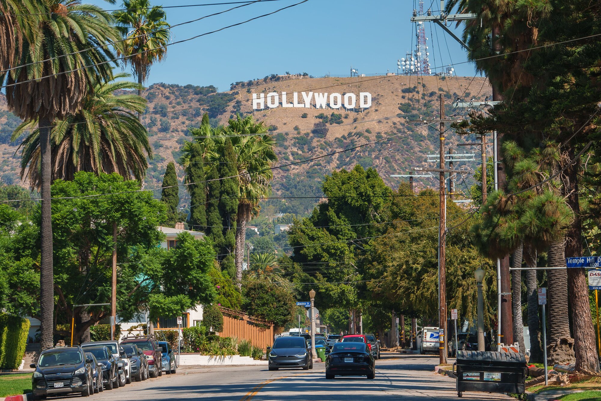 Iconic Hollywood Sign with Palm Lined Street in Los Angeles