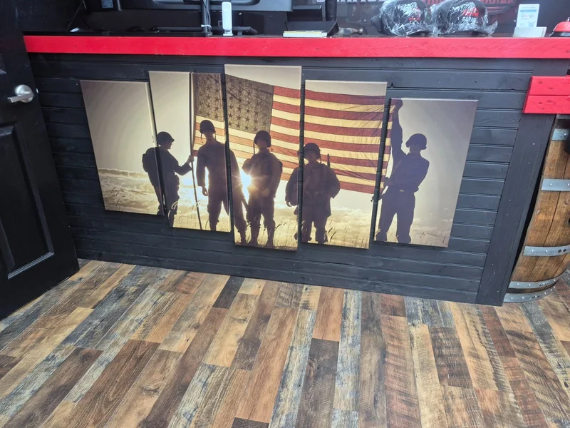 Veteran tribute wall art at Firearms Garage