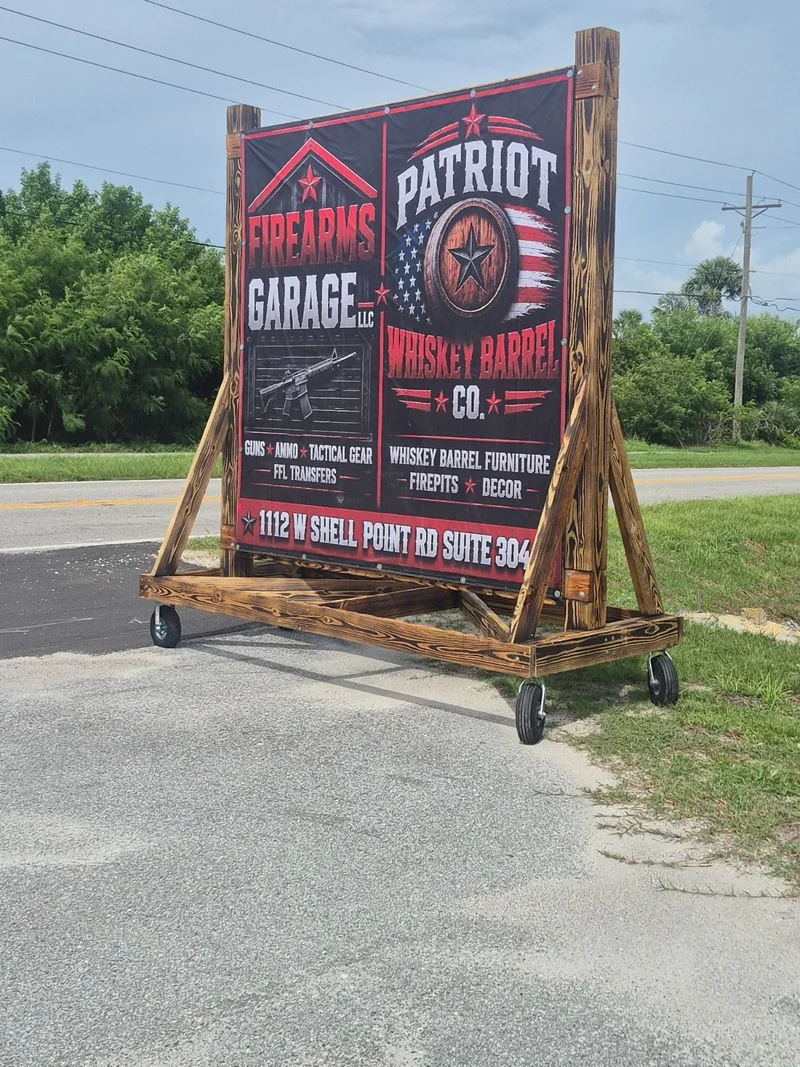 Firearms Garage and Patriot Whiskey Barrel roadside sign
