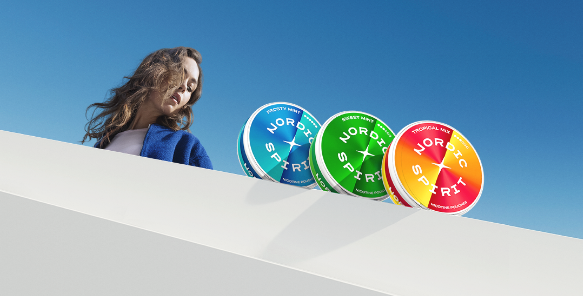 Woman looking at Nordic Spirit nicotine pouches cans