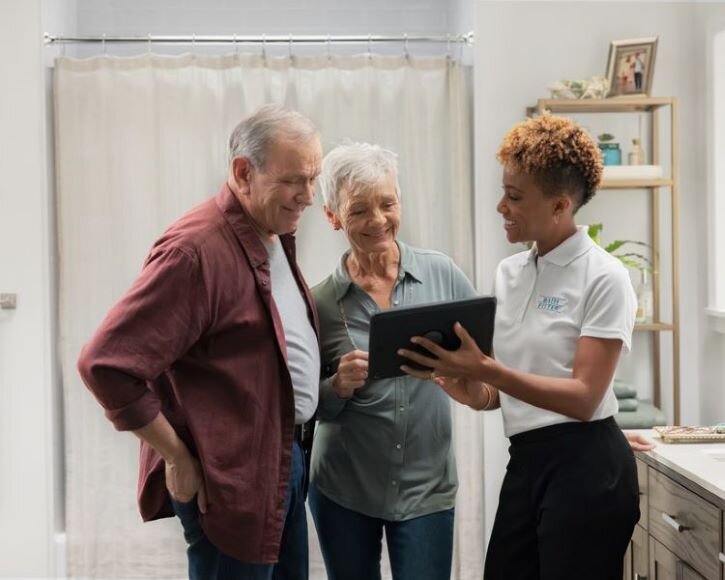 Older couple reviewing bathroom remodel options with Bath Fitter expert