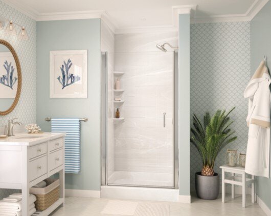 Shower remodel with shelf and glass door in clean light blue bathroom
