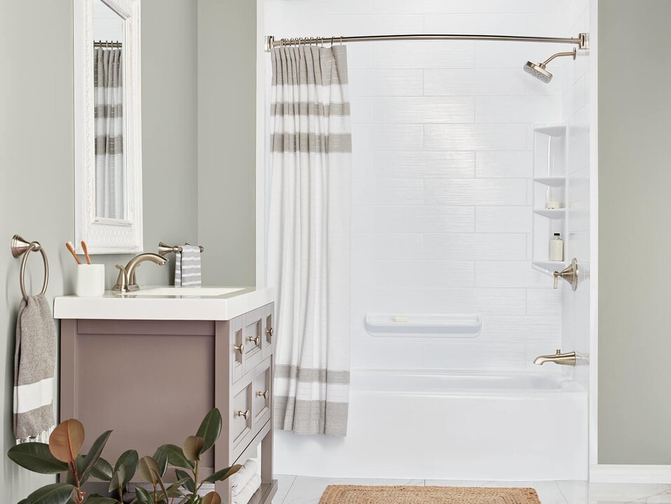 White bathroom with subway tile design and brushed nickel shower head and faucet 