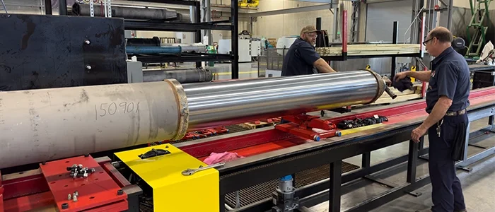 Two Motion service technicians work on a custom cylinder repair