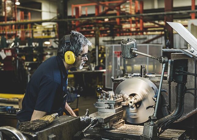 A skilled technician expertly uses a CNC mill.