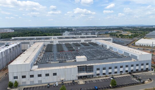 A large data center facility on a sunny day.