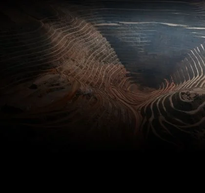 Conveyor belt transferring materials in a brightly lit mineshaft.