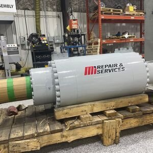 A large cylinder repaired by Motion with motion Repair & Services branding on the front.
