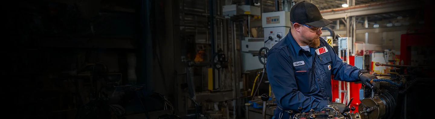 A Motion service expert works heavy machinery as he conducts a repair.
