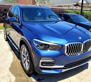 Bright blue BMW X5 SUV with stunning metallic finish and sharp angles