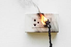 An electrical outlet on fire.