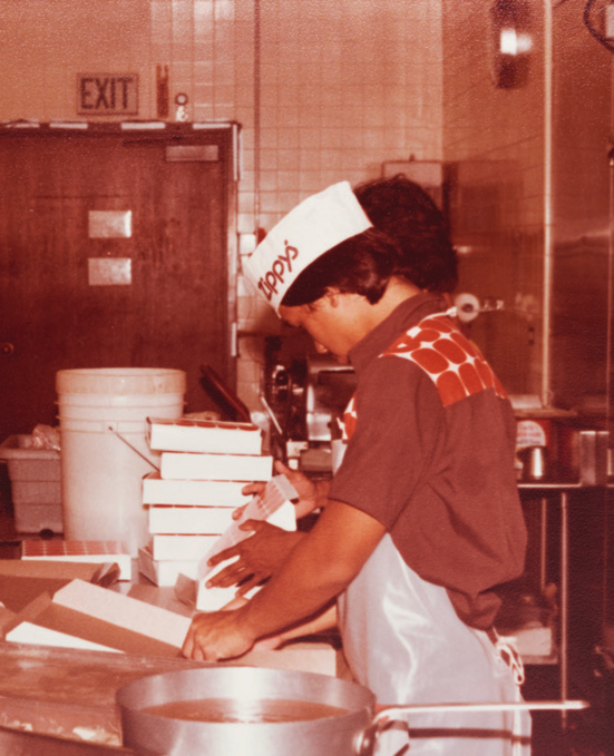 A Zippy's baker boxing pastries in the kitchen in the 1980s