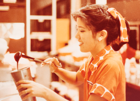 A Zippy's crew member at the counter under the new orange and brown branding