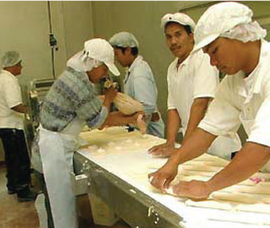 Bakers shape dough at the Napoleon's Bakery production facility