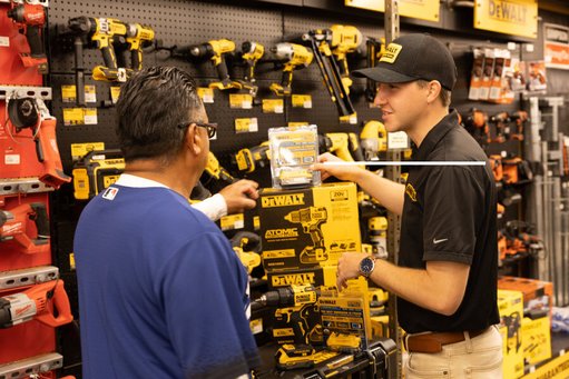 A Dewalt rep shows a drill to a customer