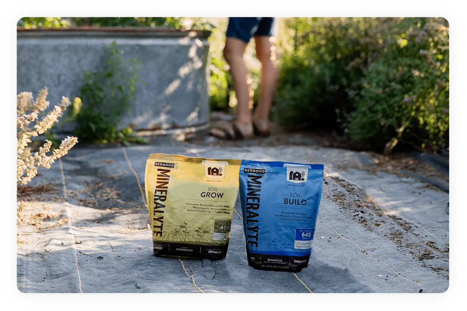 Bags of Mineralyte Build and Mineralyte Grow in a garden