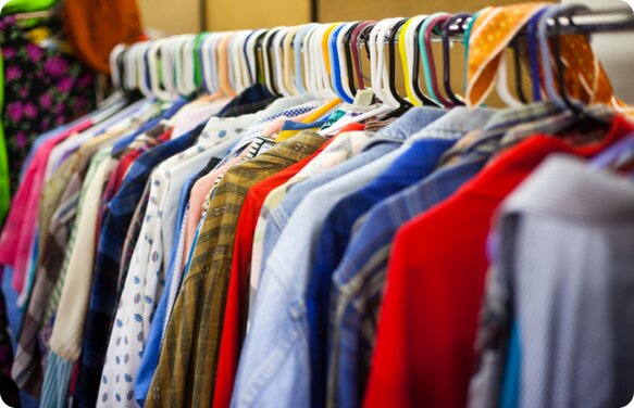 Multiply coloured shirts hanging on a clothes rack