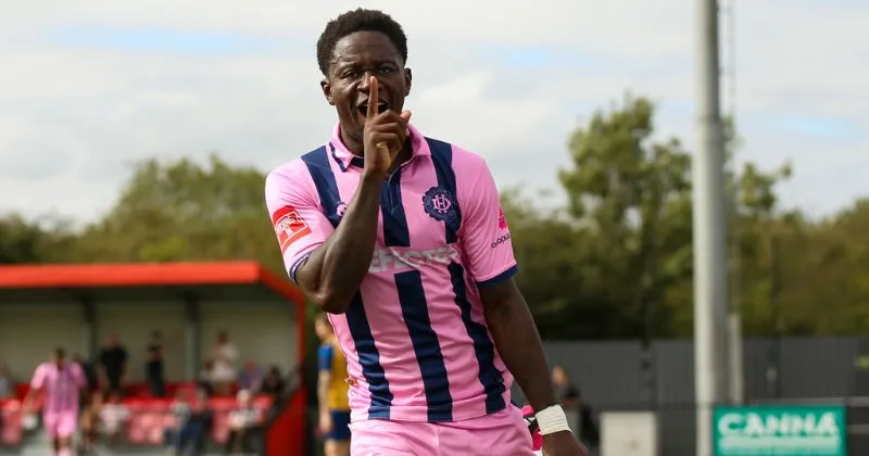 player wearing dulwich hamlet 2023-24 home shirt in pink and blue stripes