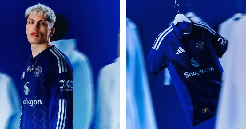 Manchester United away shirt in dark blue, with collar and silver pattern and detailing 