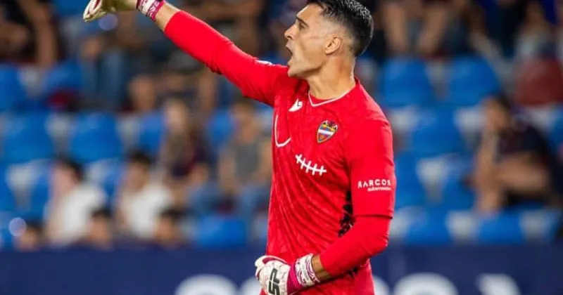 player wearing levante 2023-24 special goalkeeper shirt for breast cancer awareness in red