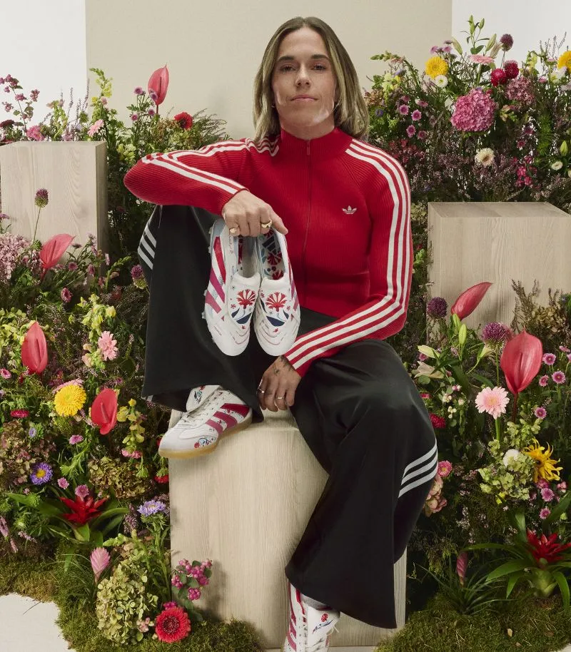 the football gal holding her adidas predator collaboration boots