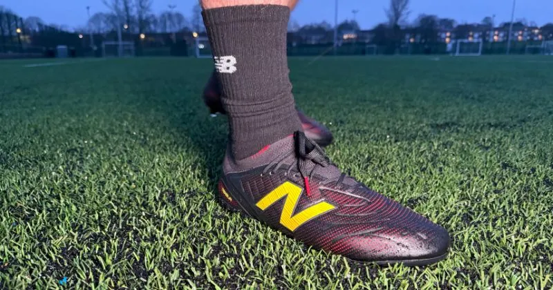 new balance tekela footall boots in black and red