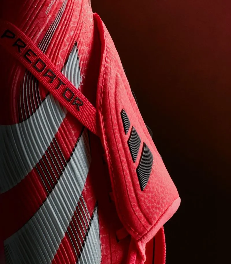 close up of adidas predatory football boots victory pack in red and white showing fold over tongue 