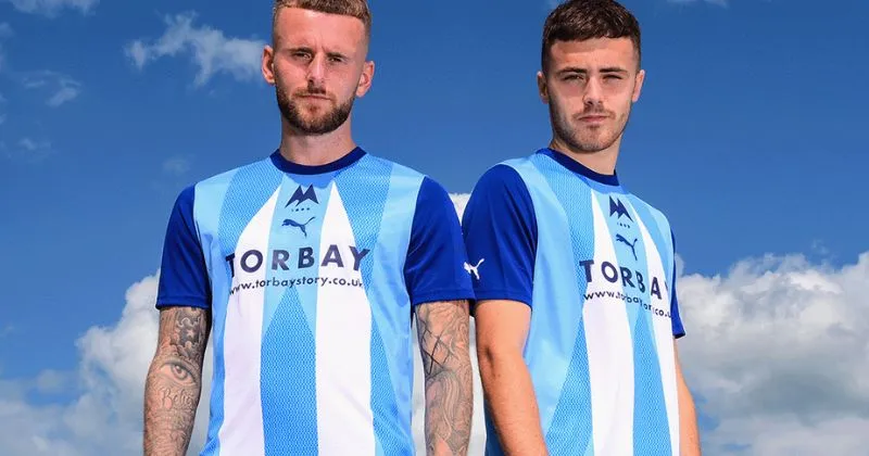 players wearing torquay united 2023-24 away shirt in white and sky blue