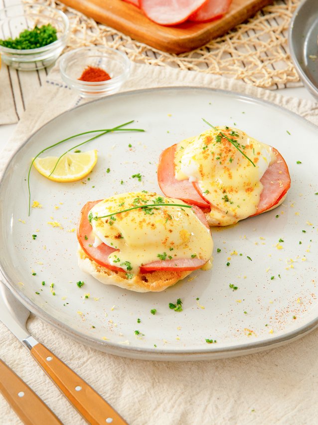 air fryer eggs benedict garnished with chives and paprika