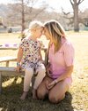 a mom and daughter touching foreheads