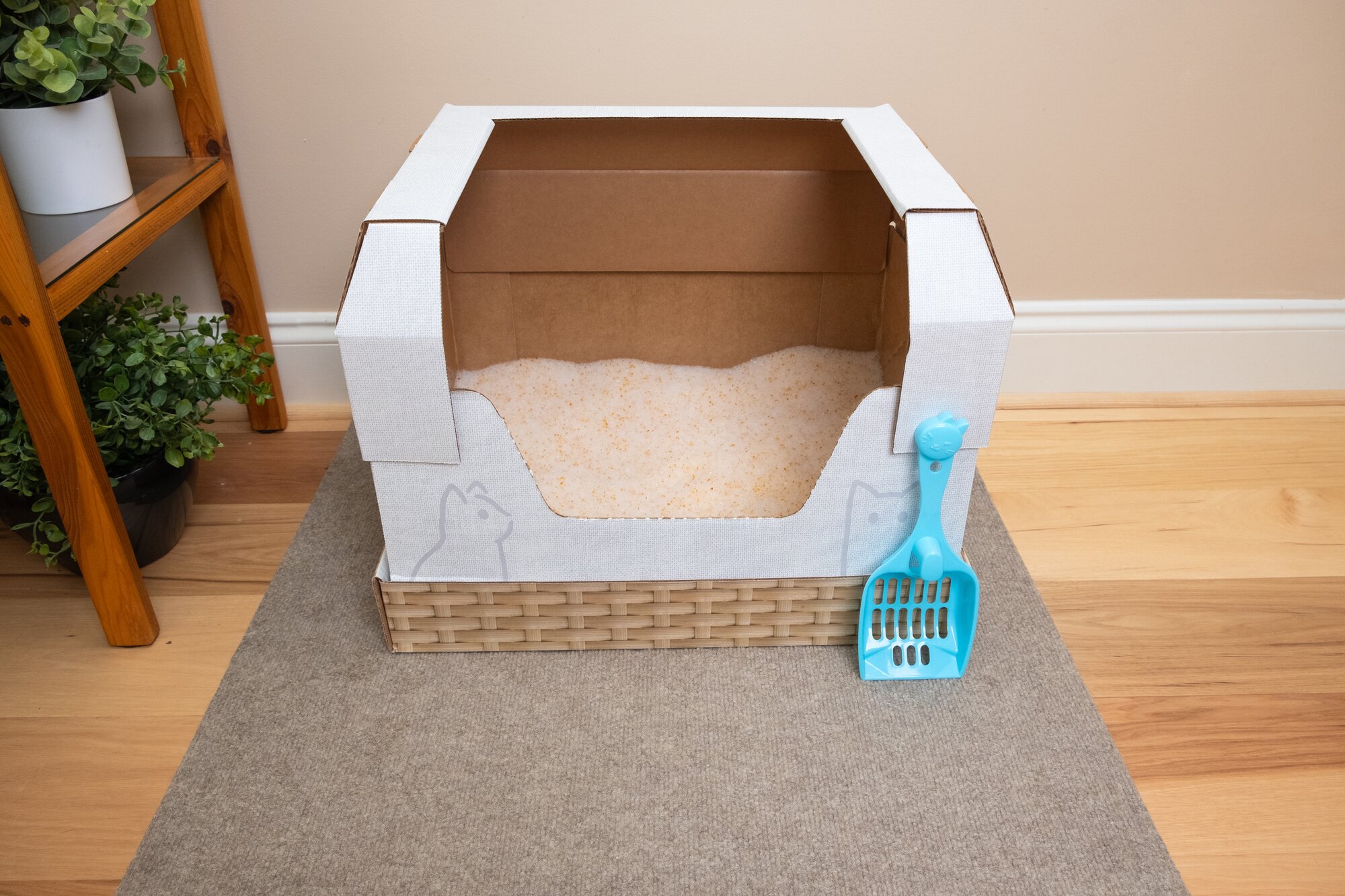 A Kitty Poo Club litter box with a dome, scoop, and mat.