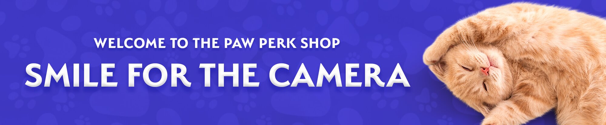 Orange tabby cat lying on its back with paws curled, next to text that reads "Welcome to the Paw Perk Shop – Smile for the Camera" on a purple paw-print background.