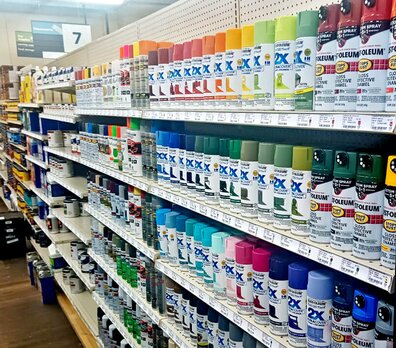 Spray paints on a display shelf