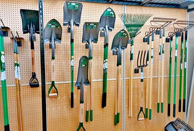 Yard tools hanging on a display wall