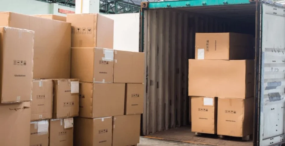 A shipping container packed with moving boxes