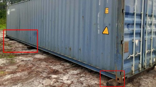 A shipping container placed on railroad ties