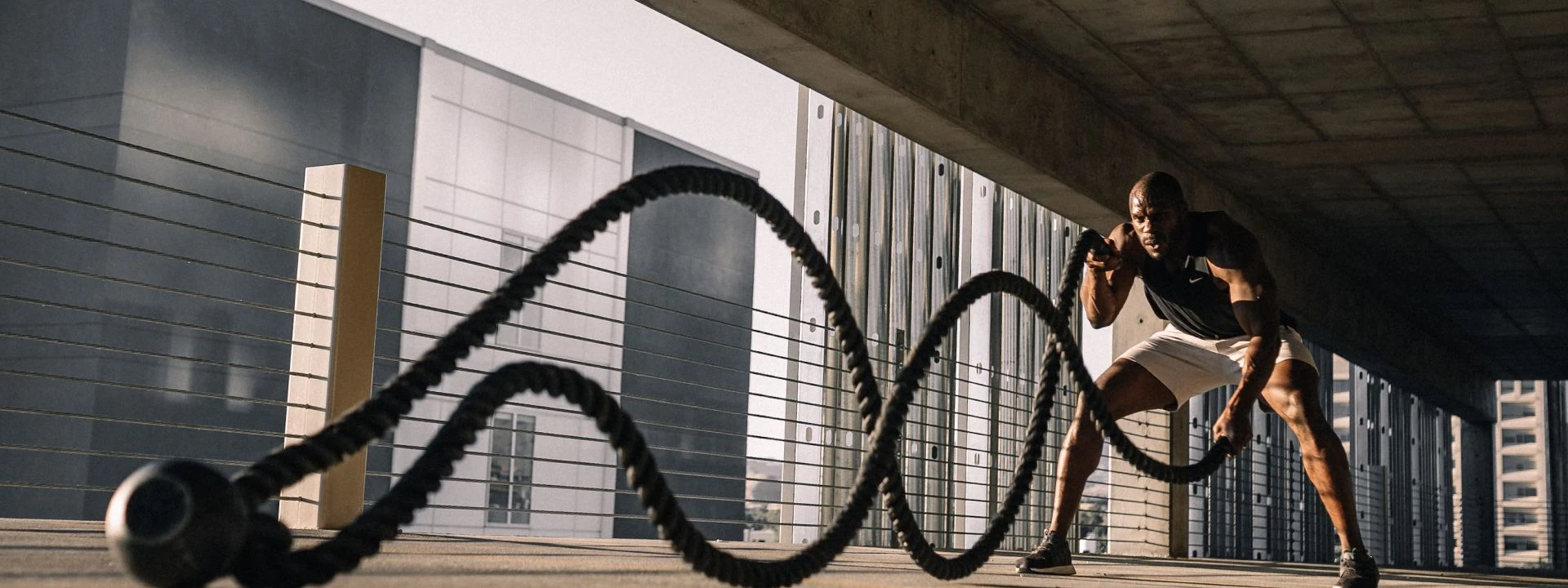 A man exercising with ropes.