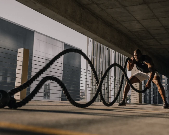 A man exercising with ropes.