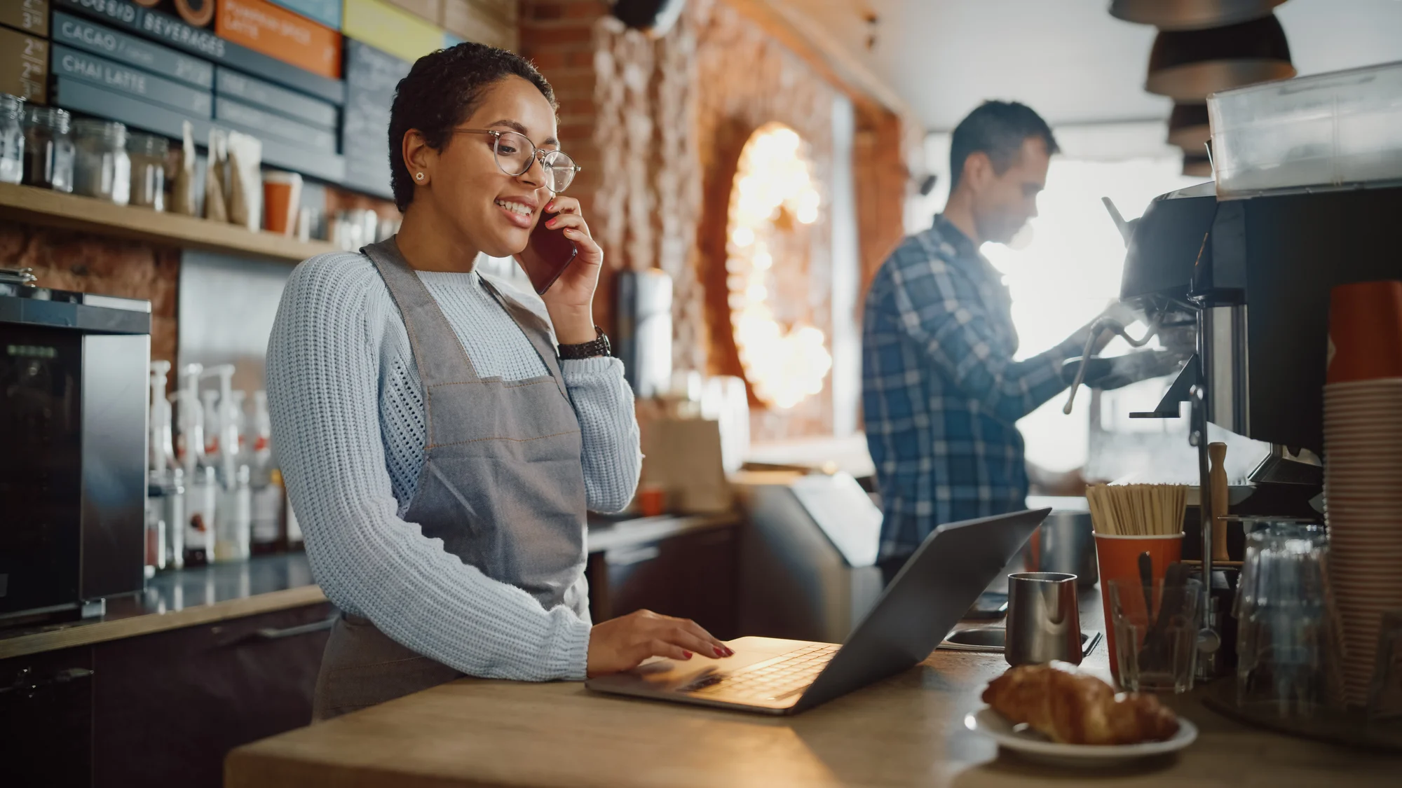 employees behind the counter at a coffee shop