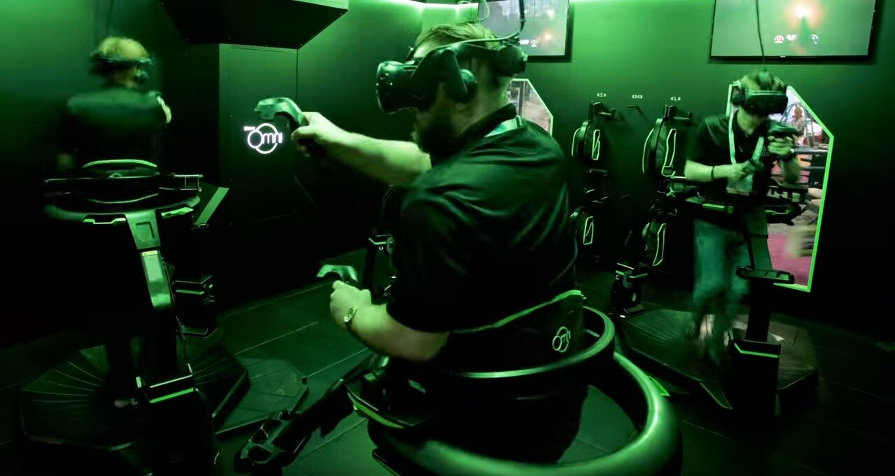 People playing VR games inside of an Omni Arena.