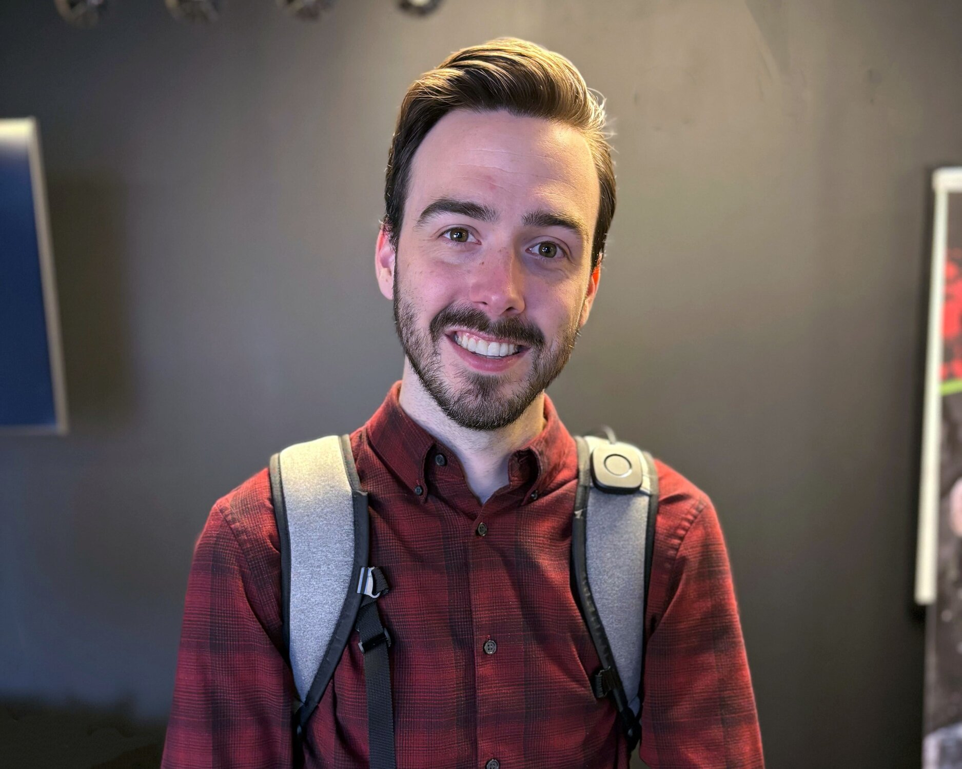 A man is smiling while wearing an Omni One vest.