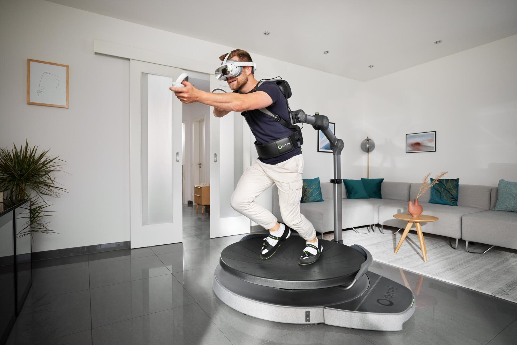 A man running on Omni One in a living room with a couch in the background.