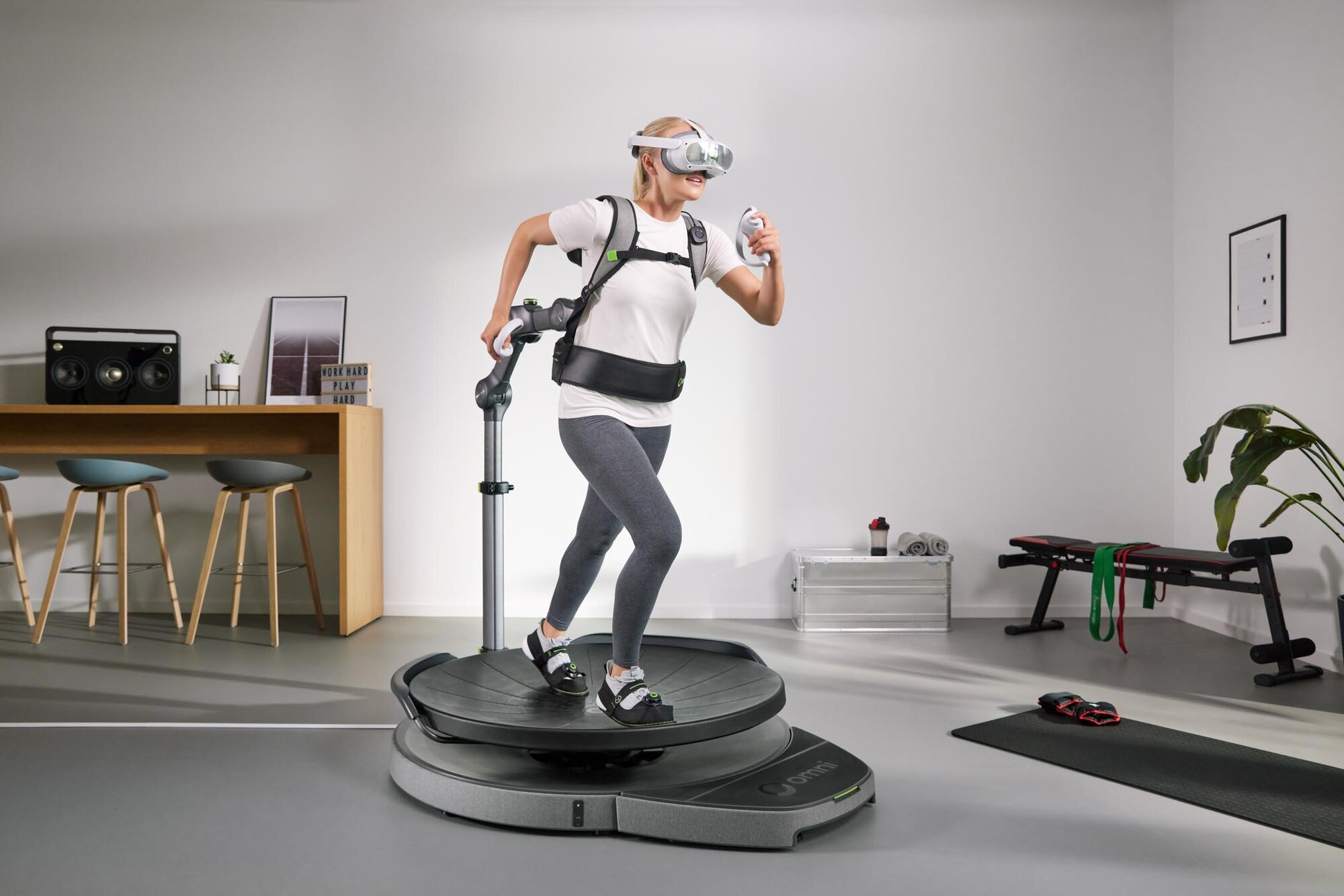 Woman running on Omni One in a workout room.