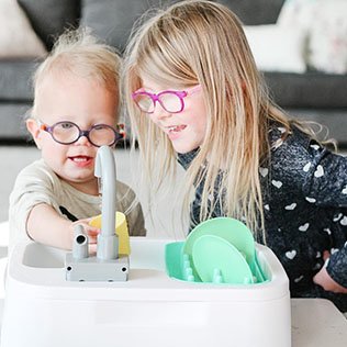 Siblings playing with Lovevery sink