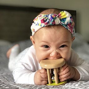 Baby with Lovevery rattle