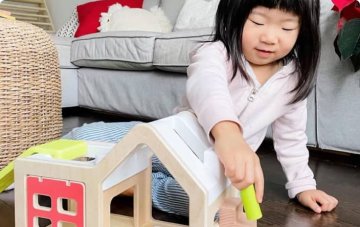 Child playing with the Modular Playhouse by Lovevery